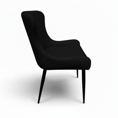 Direct Furniture Depot Miami black dining chair with diamond-pattern stitching and slim black metal legs, side view.