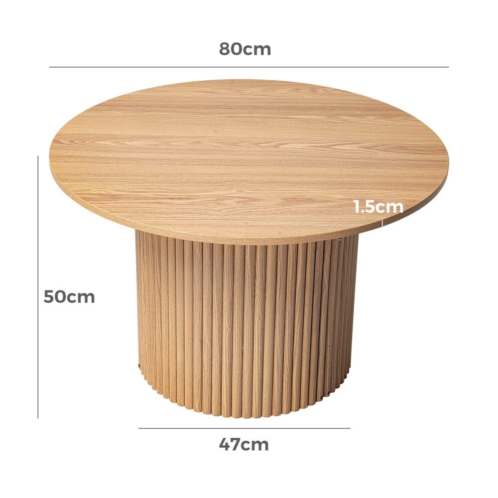 Direct Furniture Depot Cove round coffee table with a natural wood grain finish and ribbed cylindrical base.